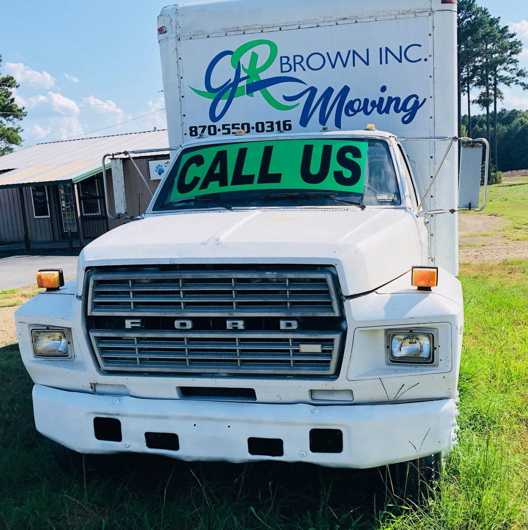 A white truck with a call us sign on the front
