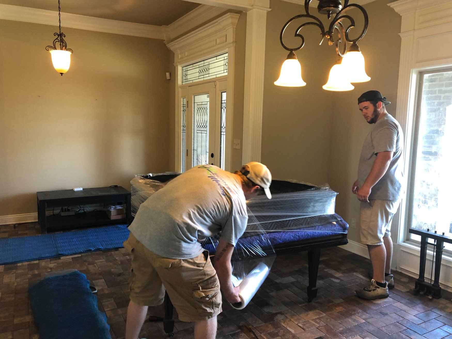 jr brown employees preparing large piano for move