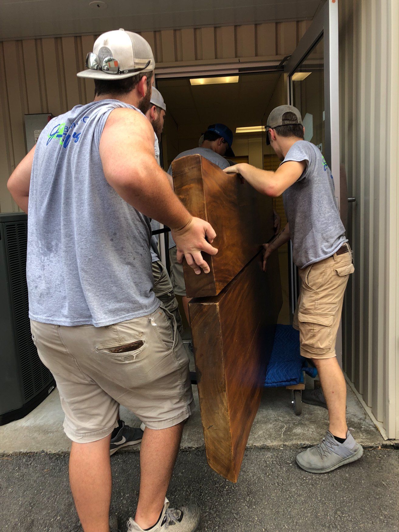 jr brown employees moving large furniture in heat
