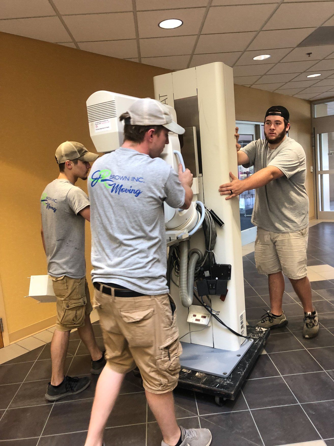 jr brown employees moving xray machine