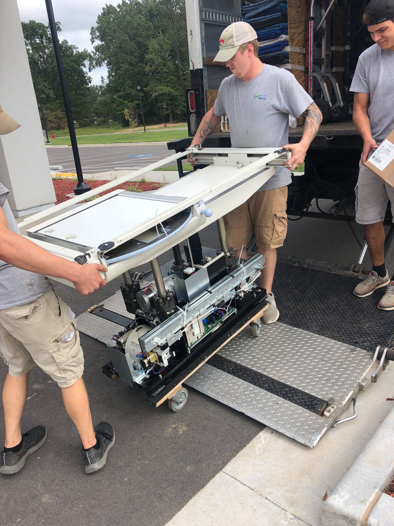 jr brown employees moving medical imaging equipment