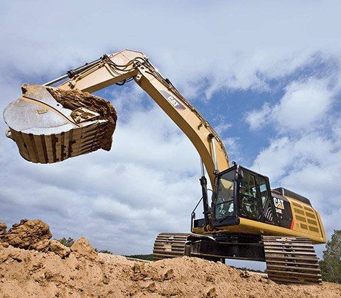 Road Building — Excavator loading Dumper Truck in Jonesboro, AR