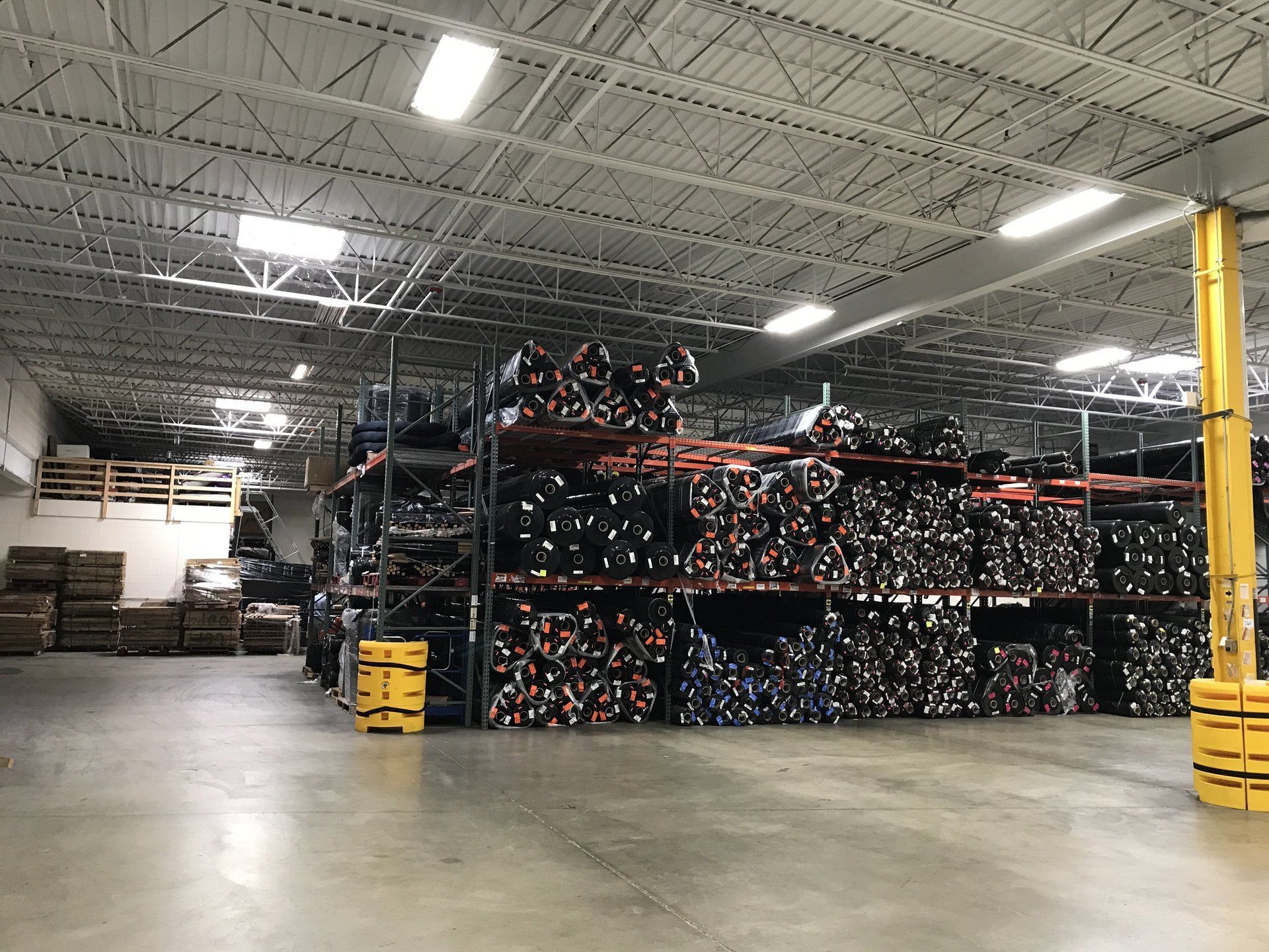 A large warehouse filled with lots of shelves and pallets.