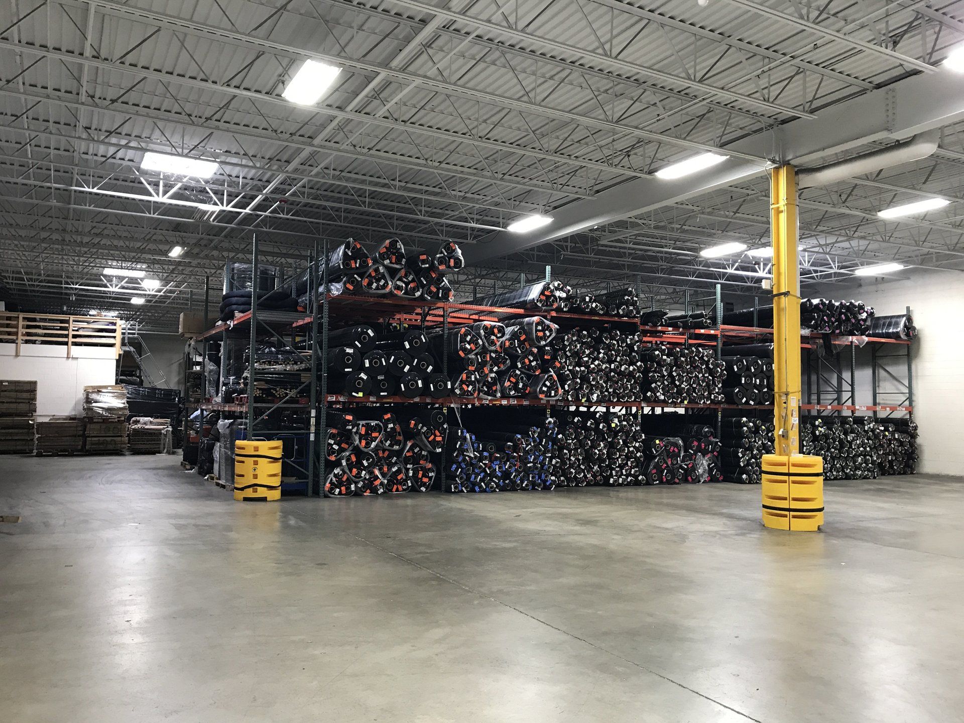 A large warehouse filled with lots of shelves and pallets.