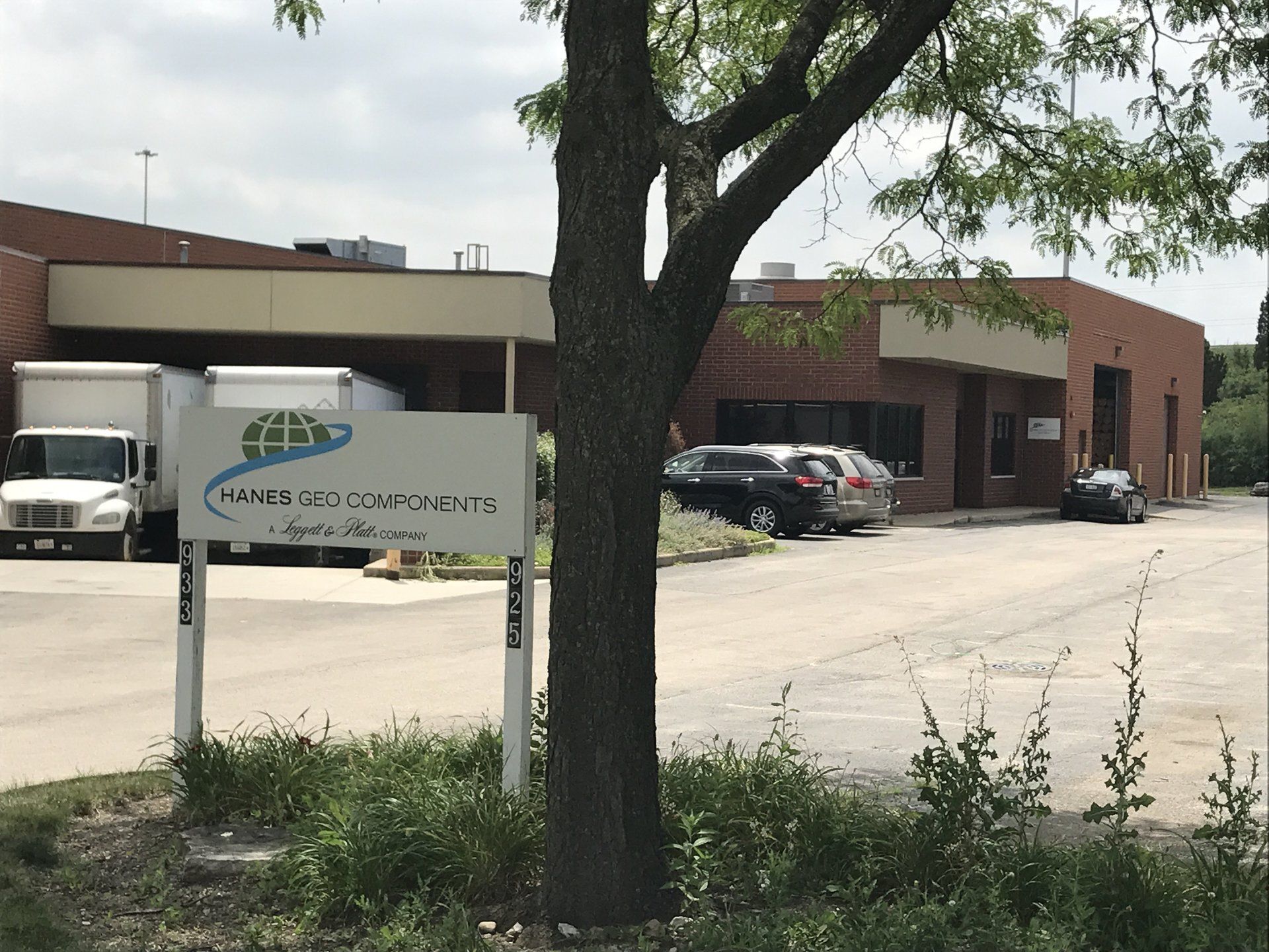 A large brick building with a white sign in front of it