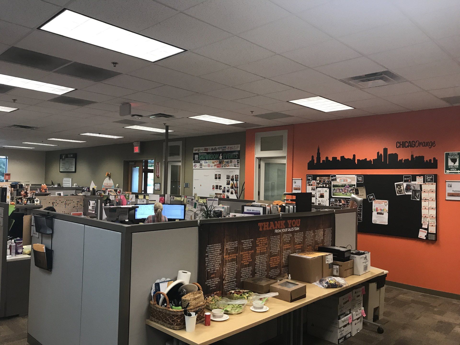 A large office with lots of cubicles and tables