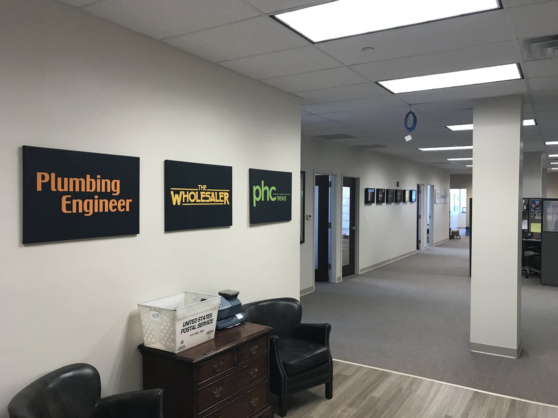 A hallway with signs on the wall that say plumbing engineer