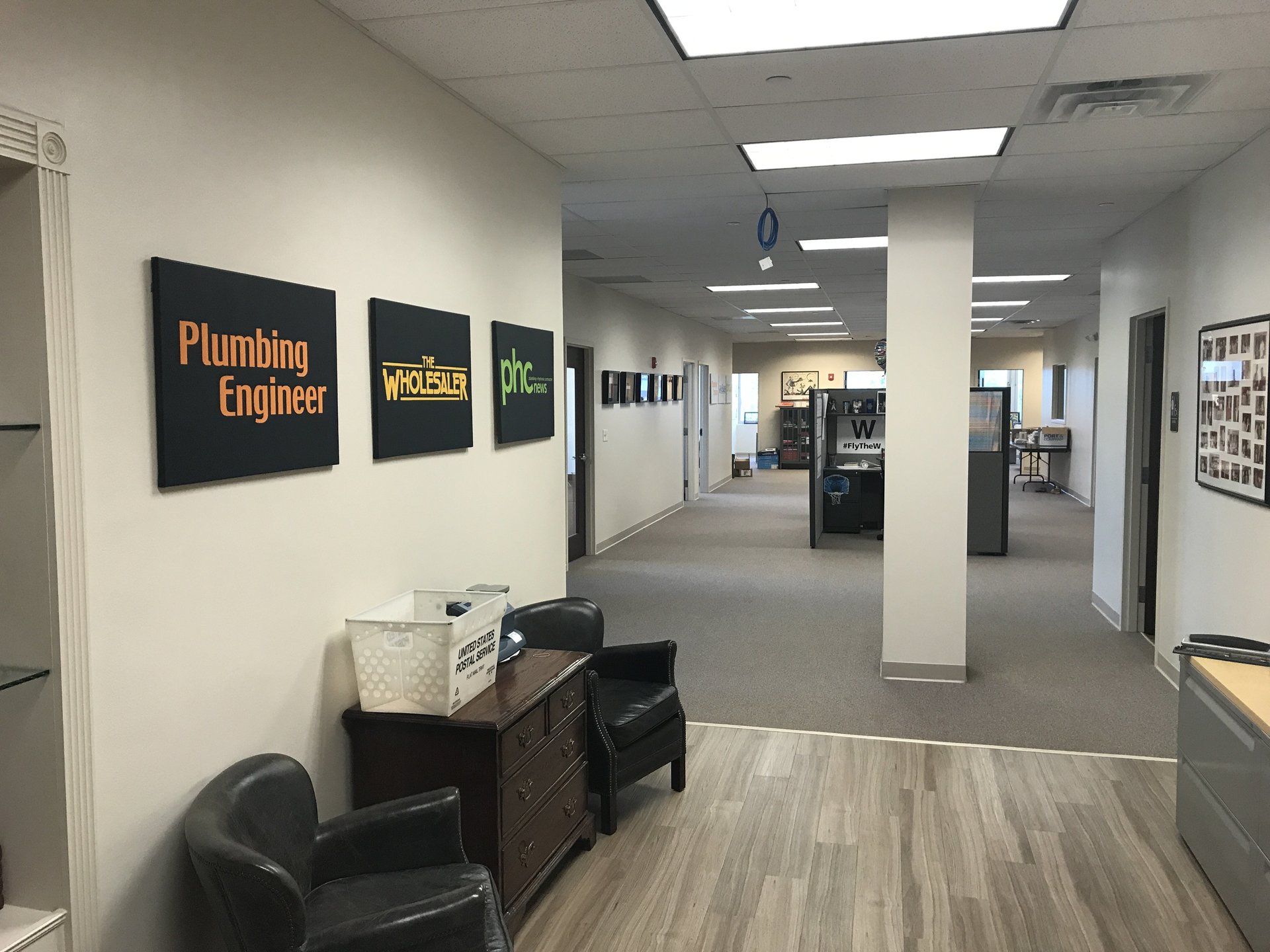A hallway with signs on the wall that say plumbing engineer