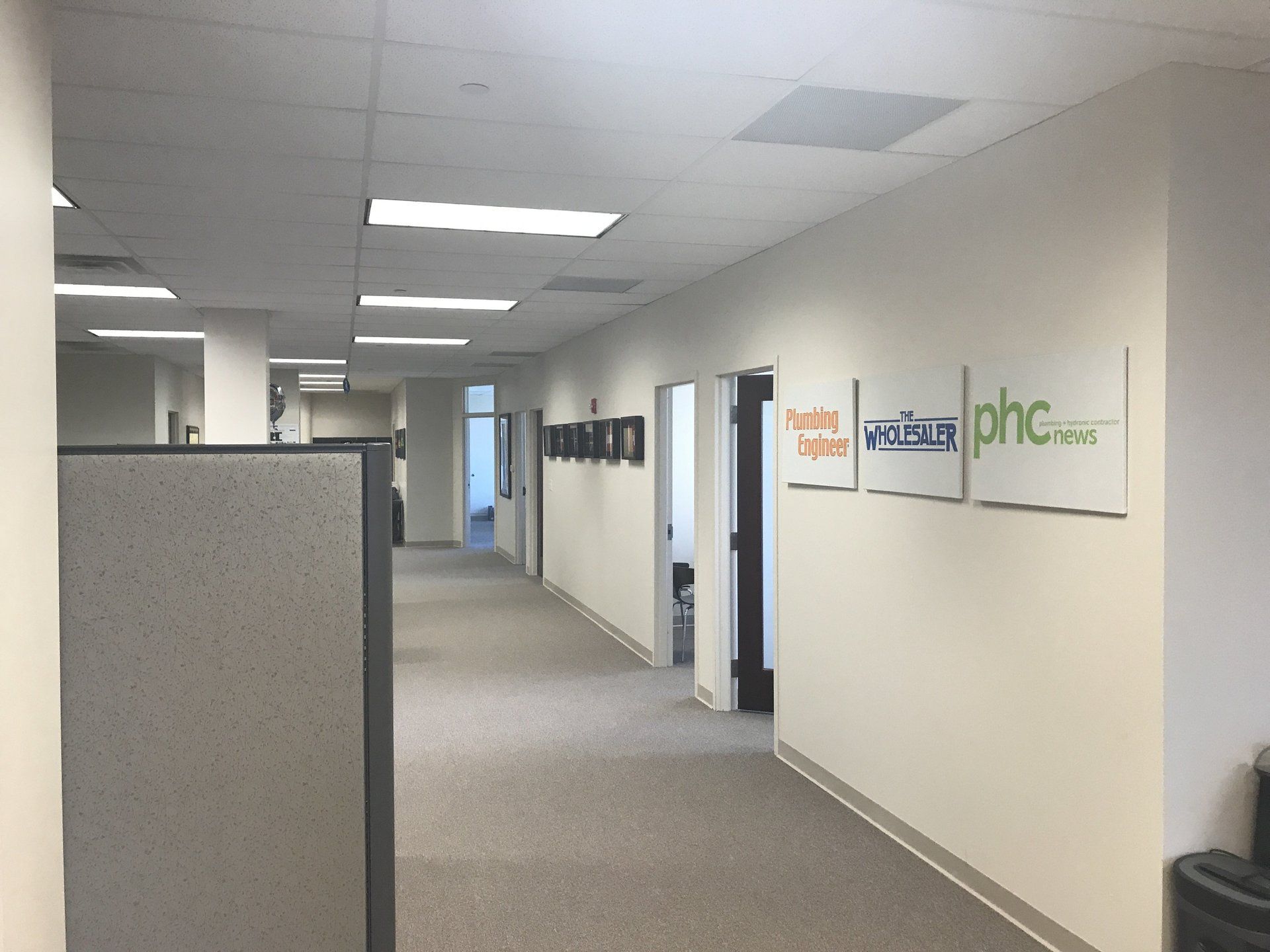A hallway in an office with a sign that says phc on it