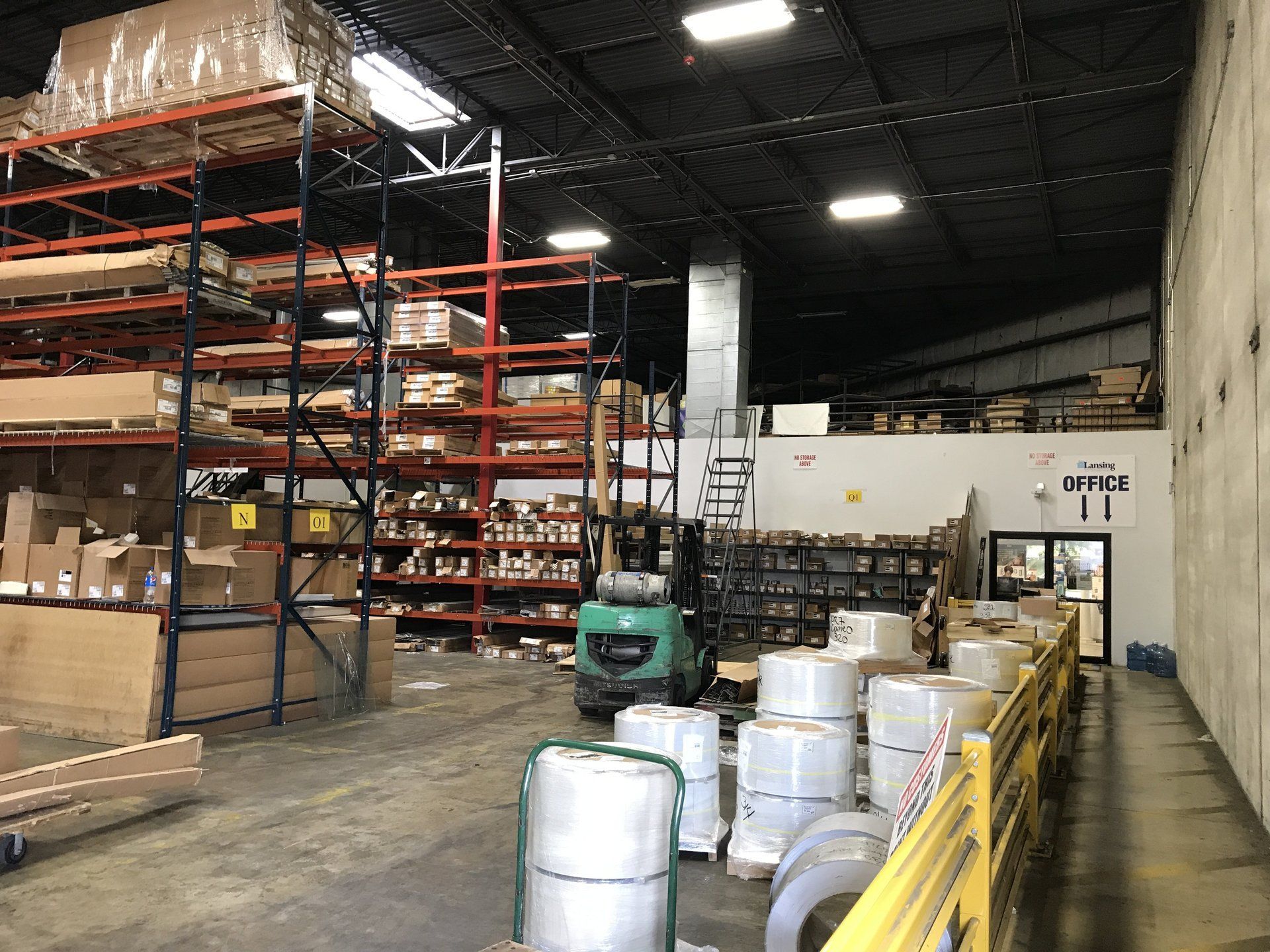 A large warehouse filled with lots of barrels and shelves.