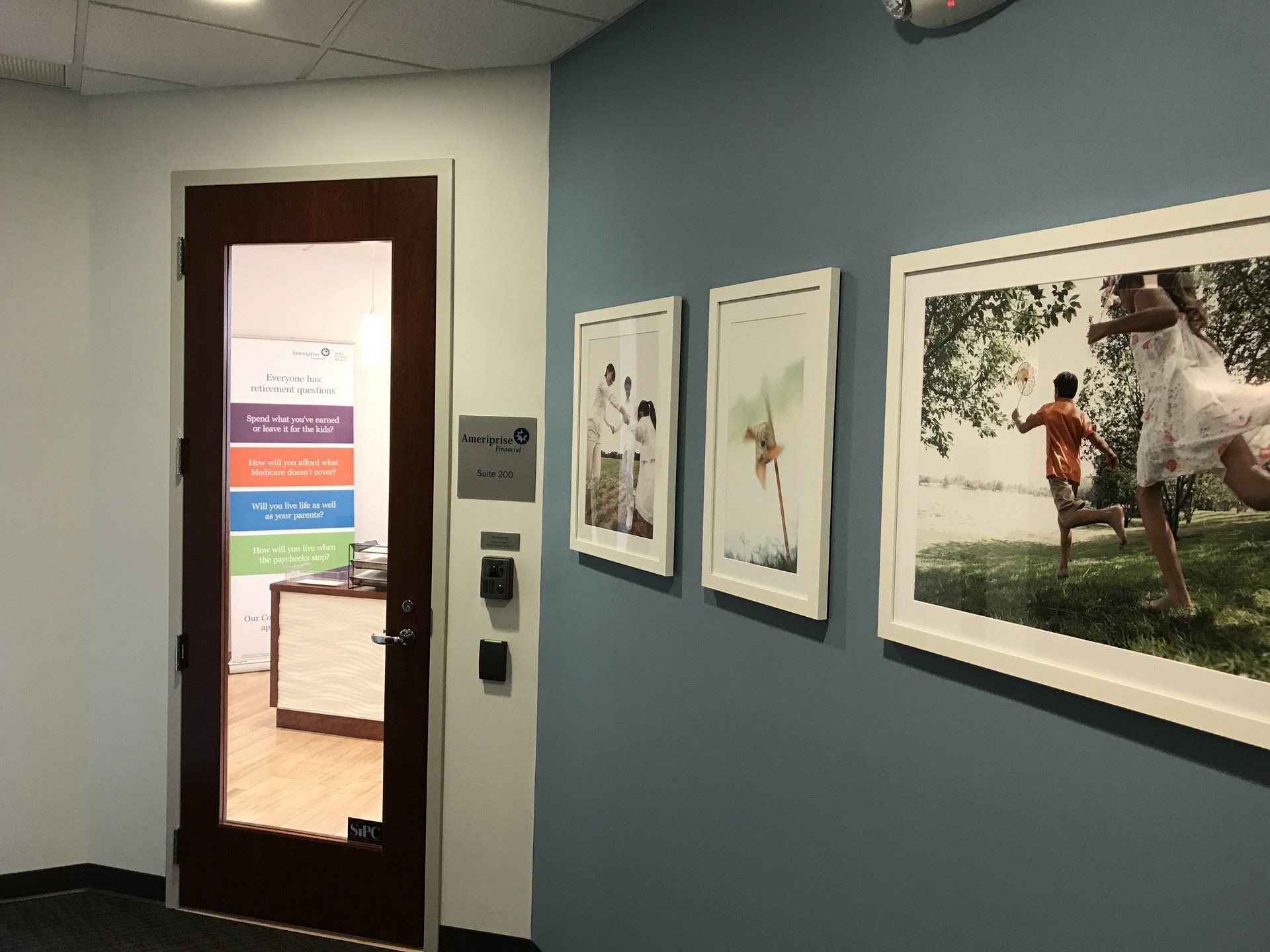 A hallway with a door and pictures on the wall