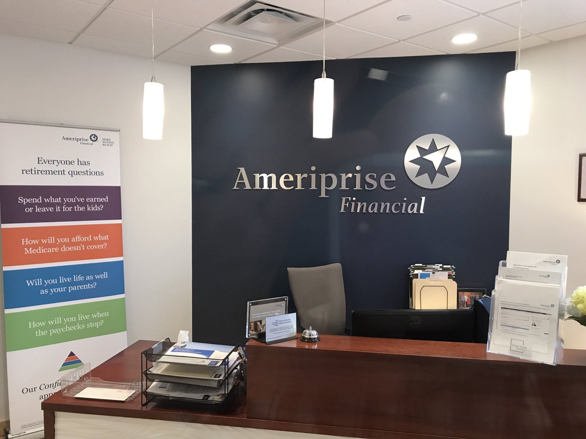 The inside of a ameriprise financial office with a desk and chair.
