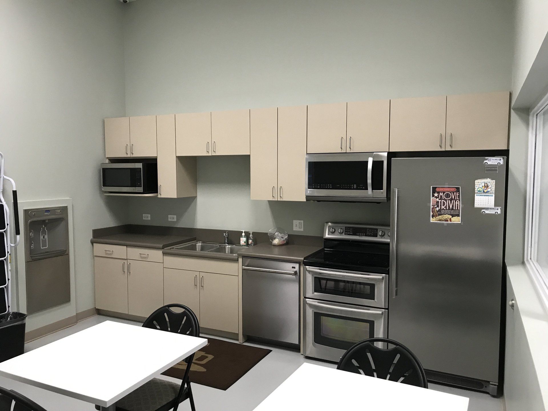 A kitchen with stainless steel appliances and white cabinets