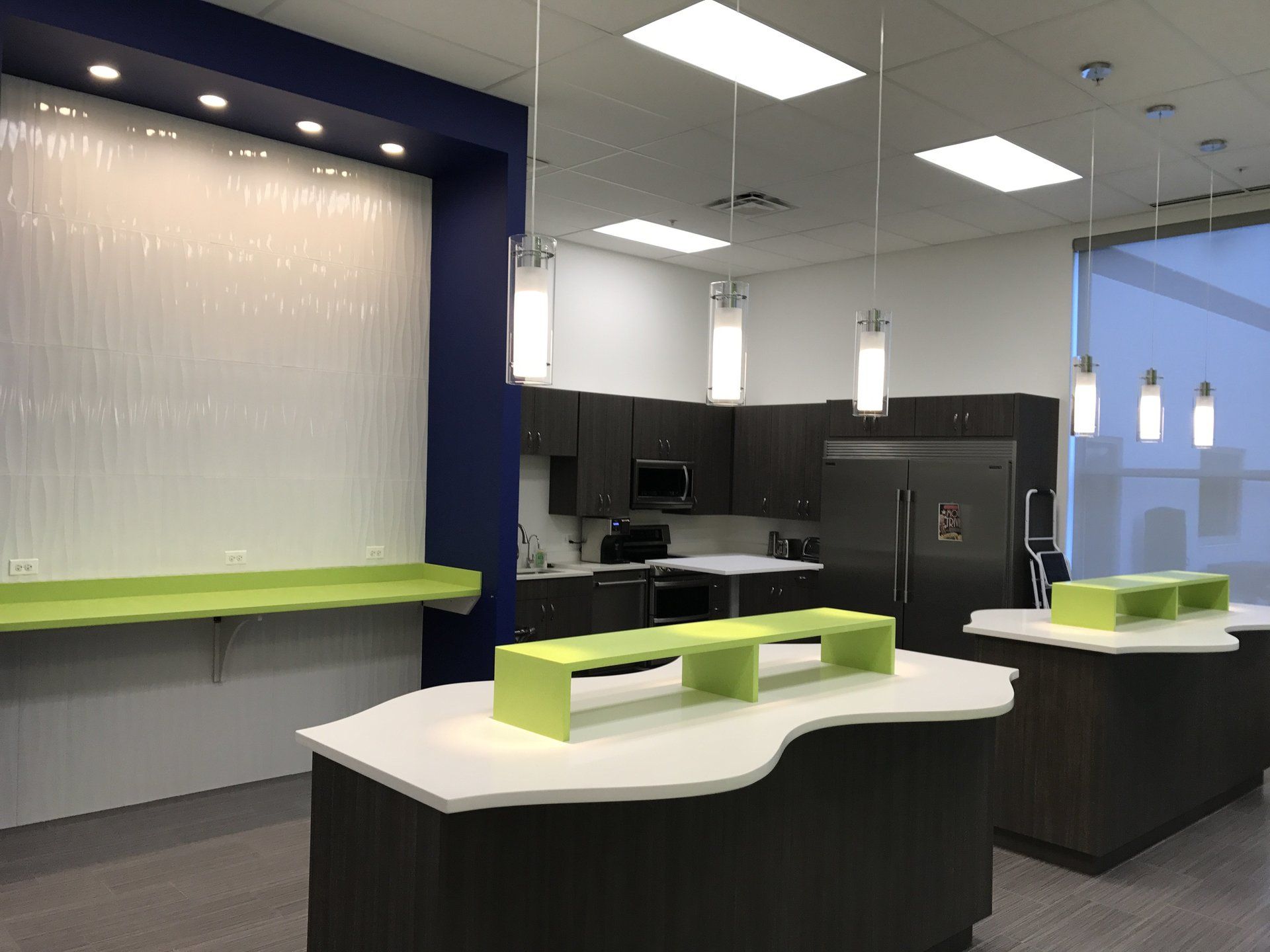 A kitchen with green counter tops and a refrigerator