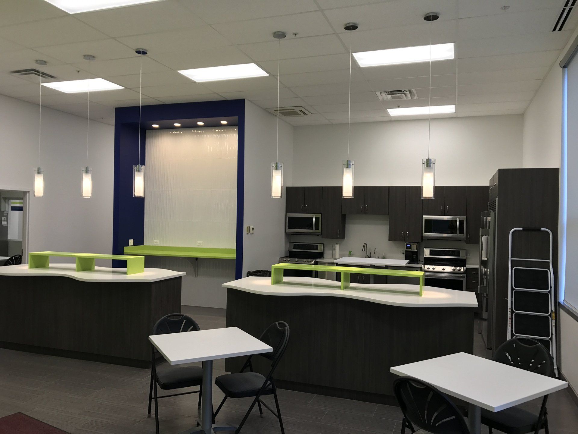 A kitchen with a lot of tables and chairs