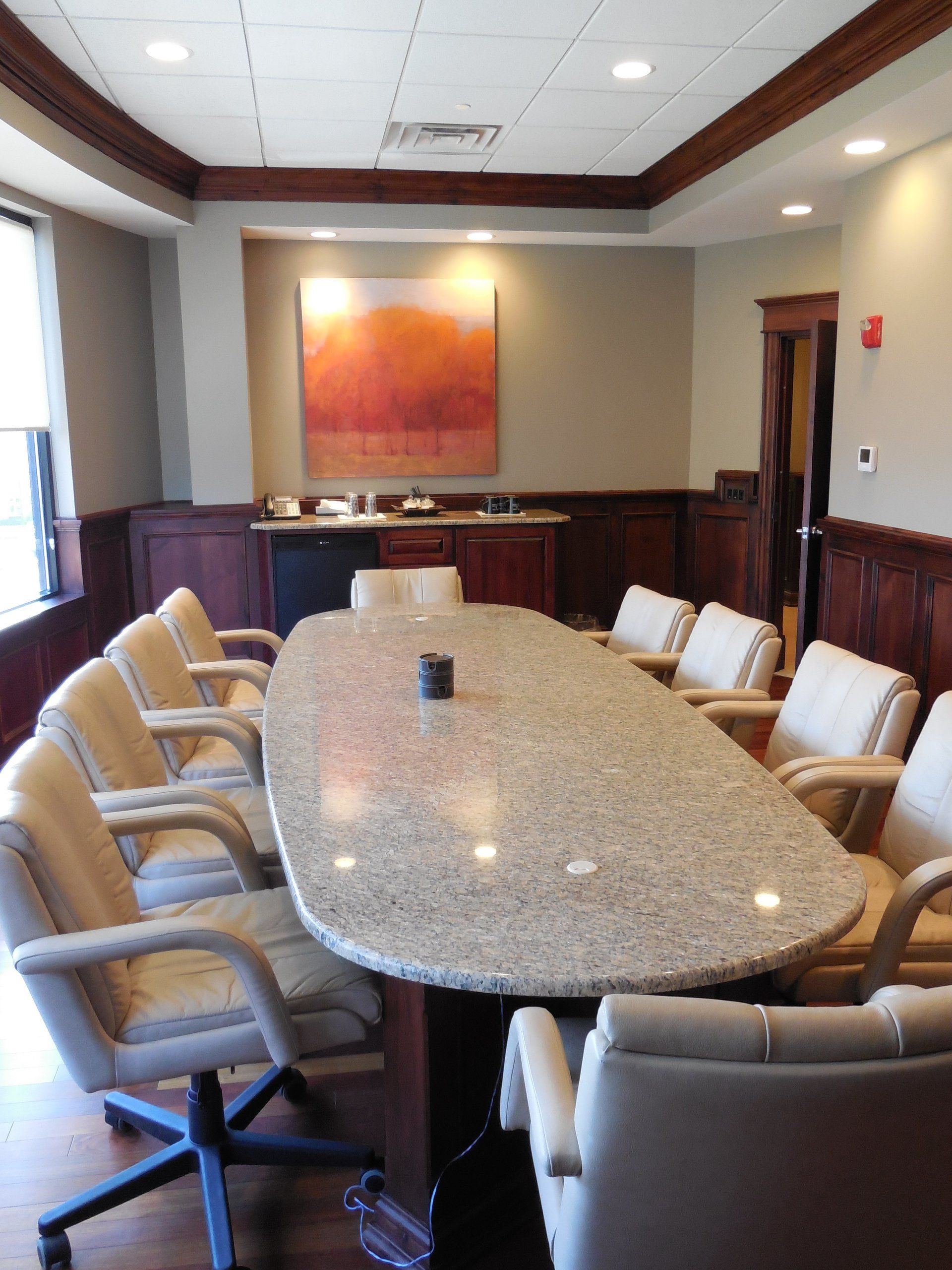 A conference room with a long table and chairs