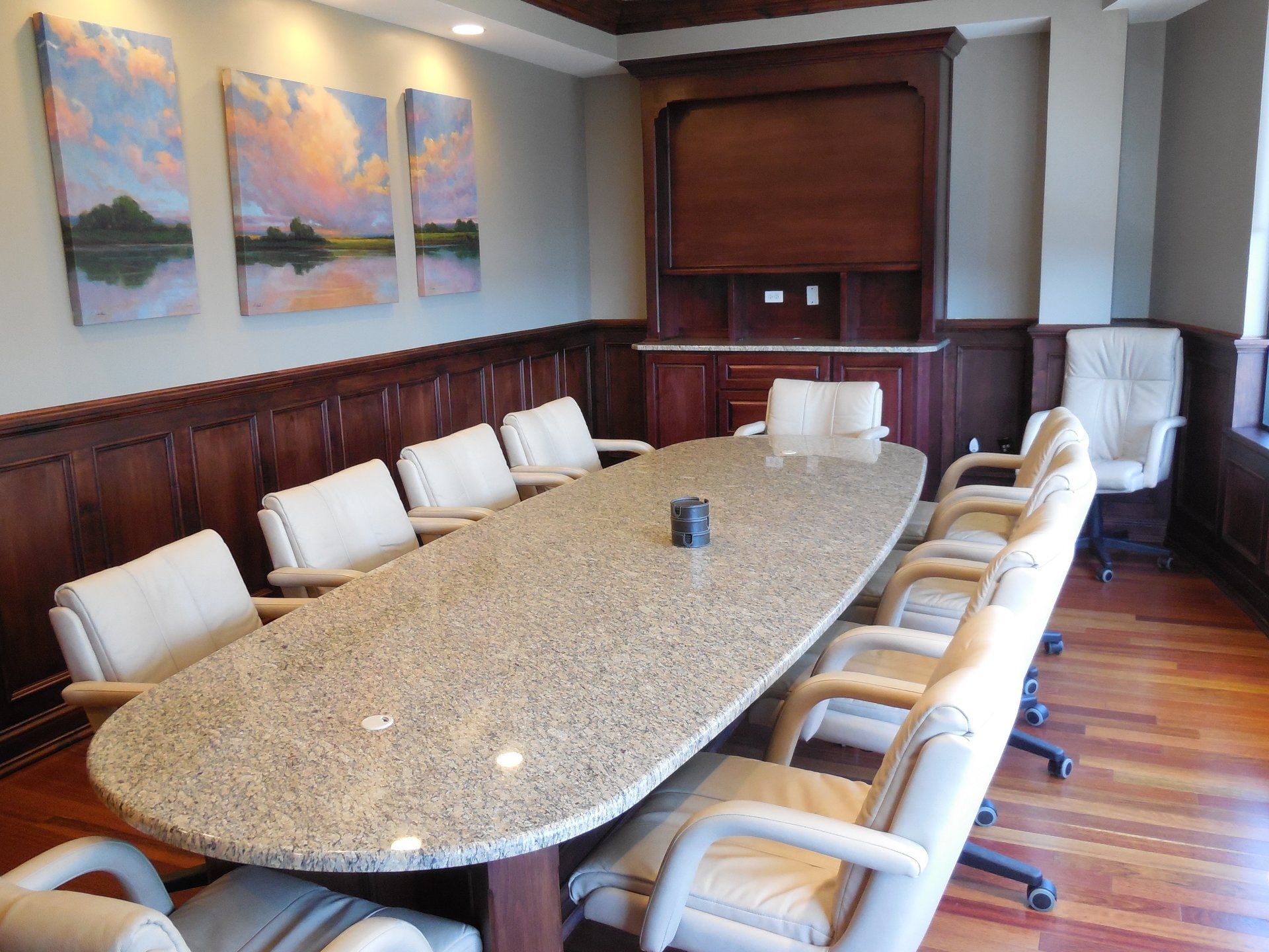 A conference room with a long table and chairs