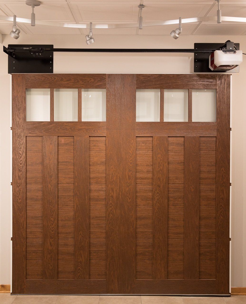 A wooden garage door with a motor attached to it