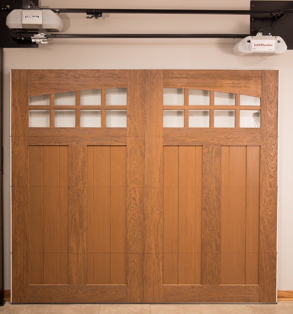 A wooden garage door with a lynx brand garage door opener