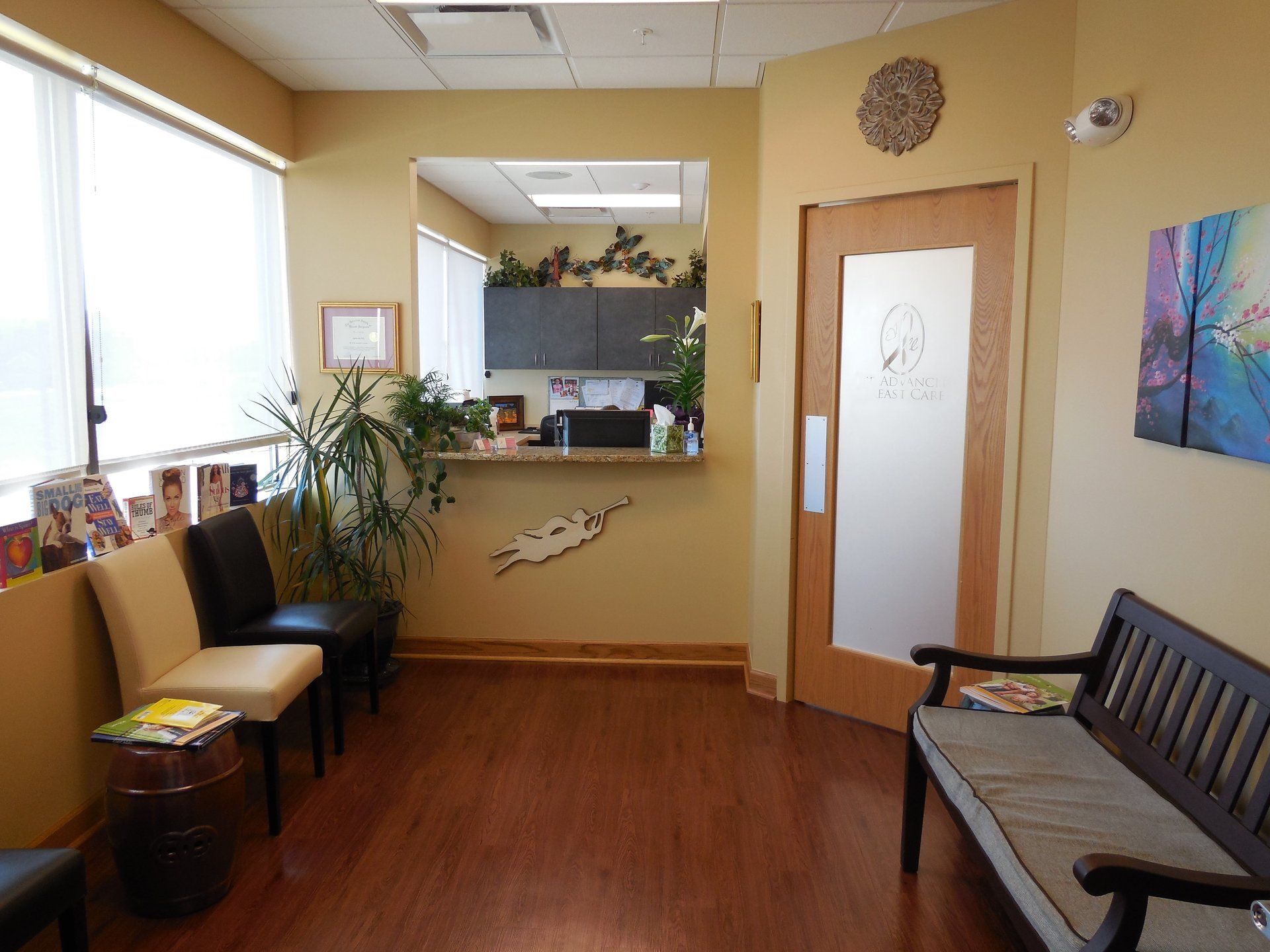 A waiting room with a bench , chairs and a counter.