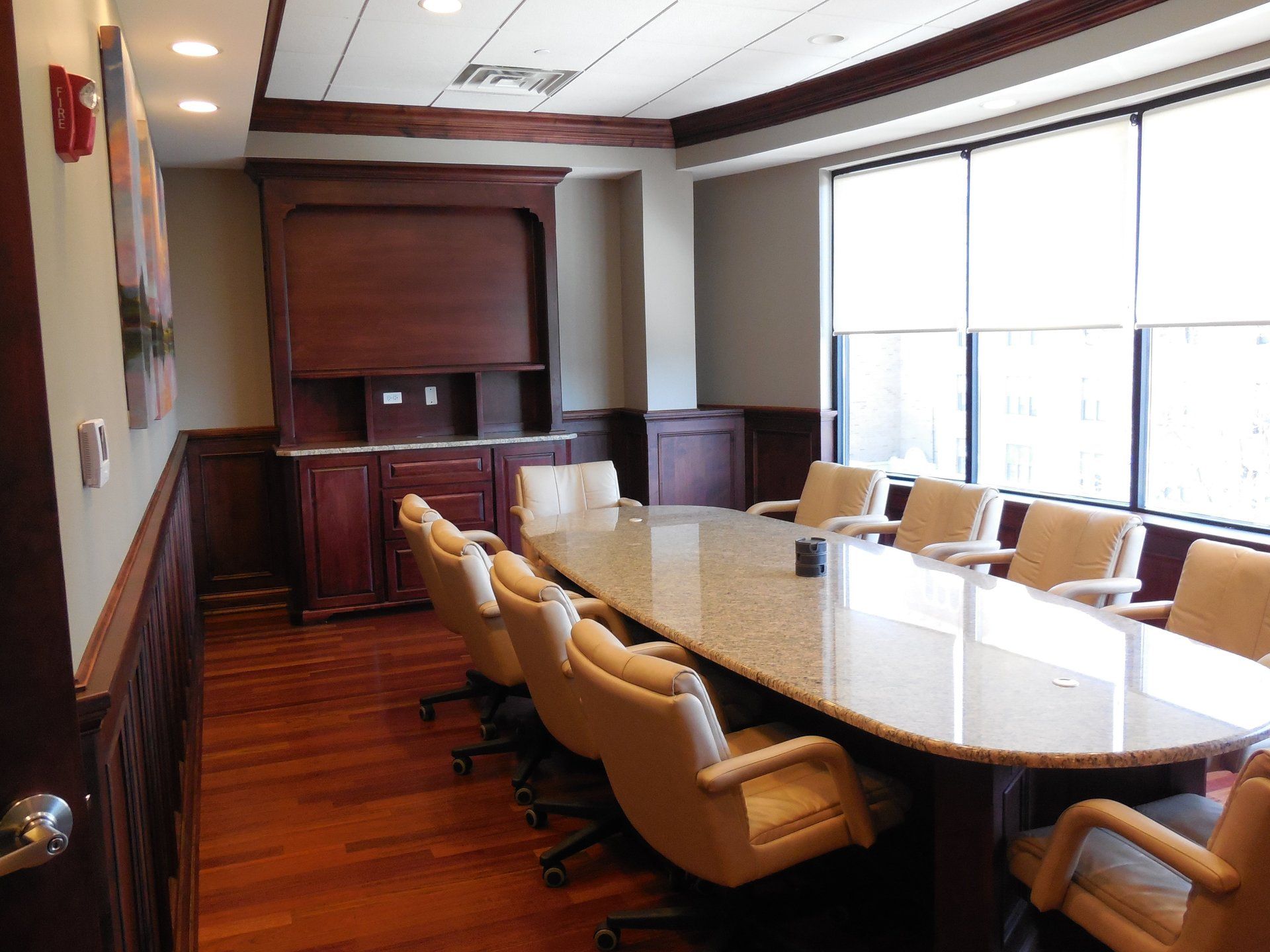 A conference room with a long table and chairs