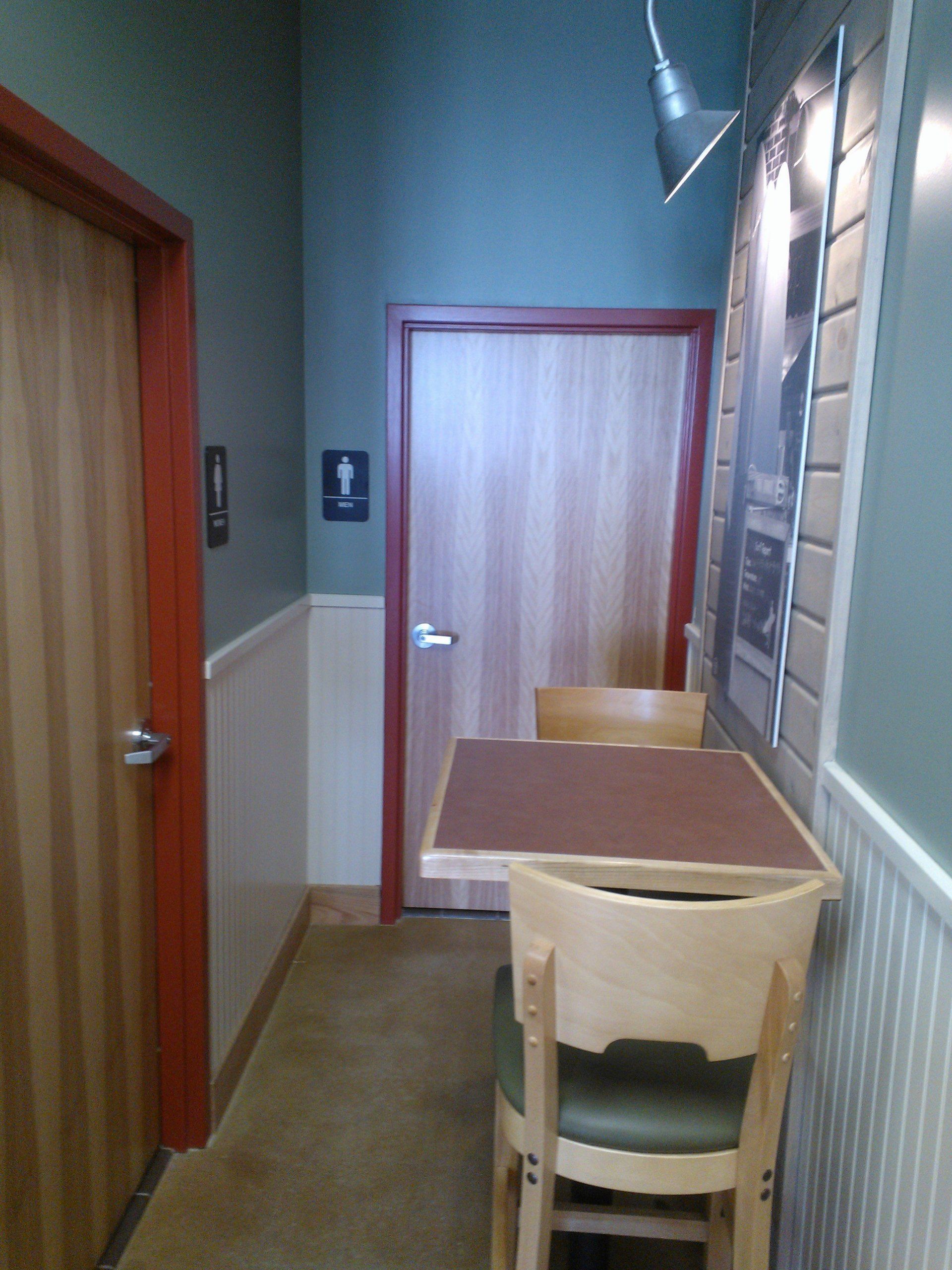 A hallway with a table and chairs in it
