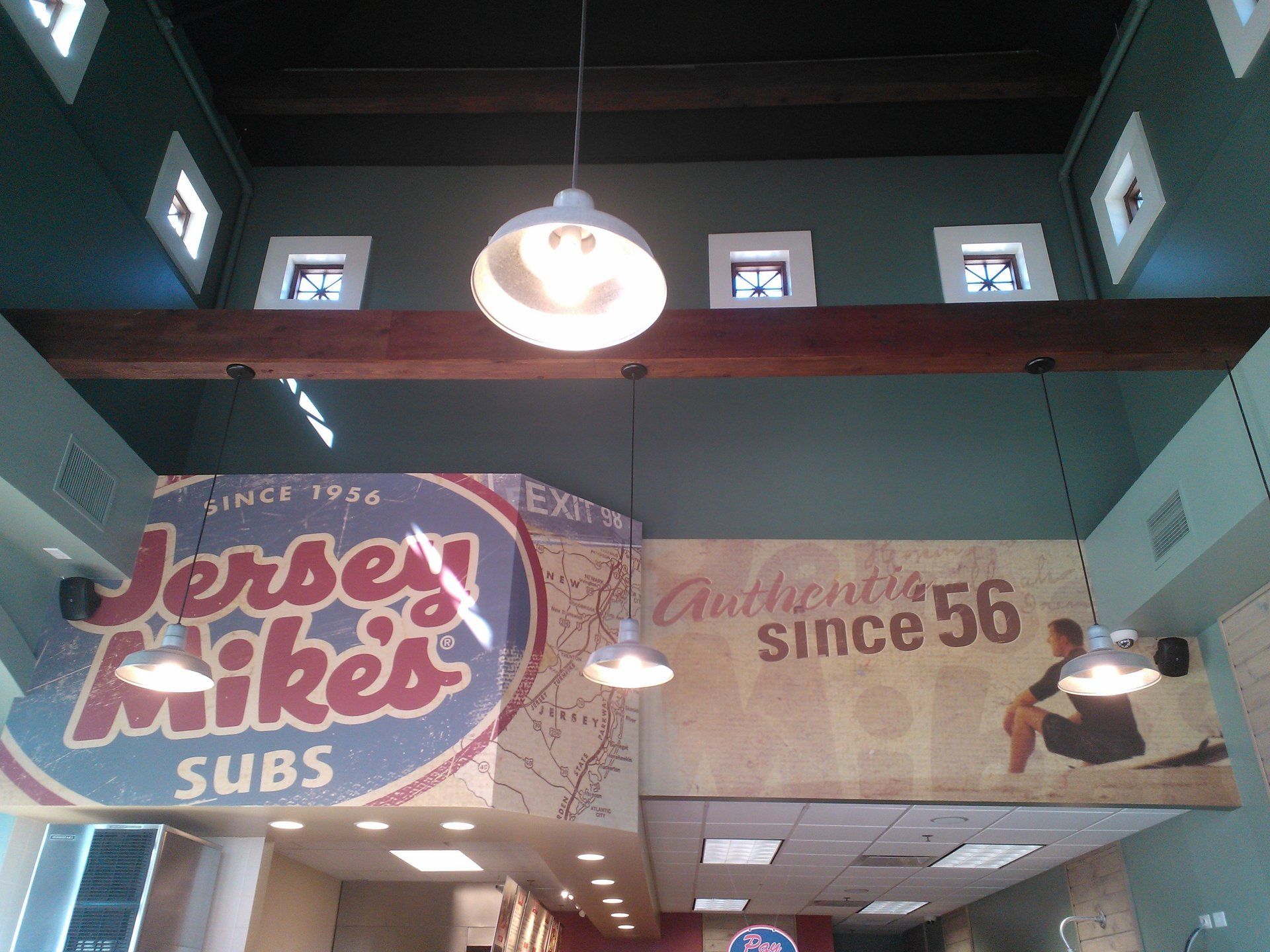 A jersey mikes subs sign hangs from the ceiling