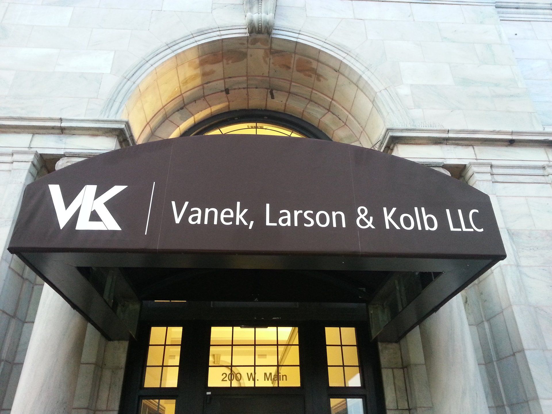 Vanek larson & kolb llc has a brown awning over their entrance