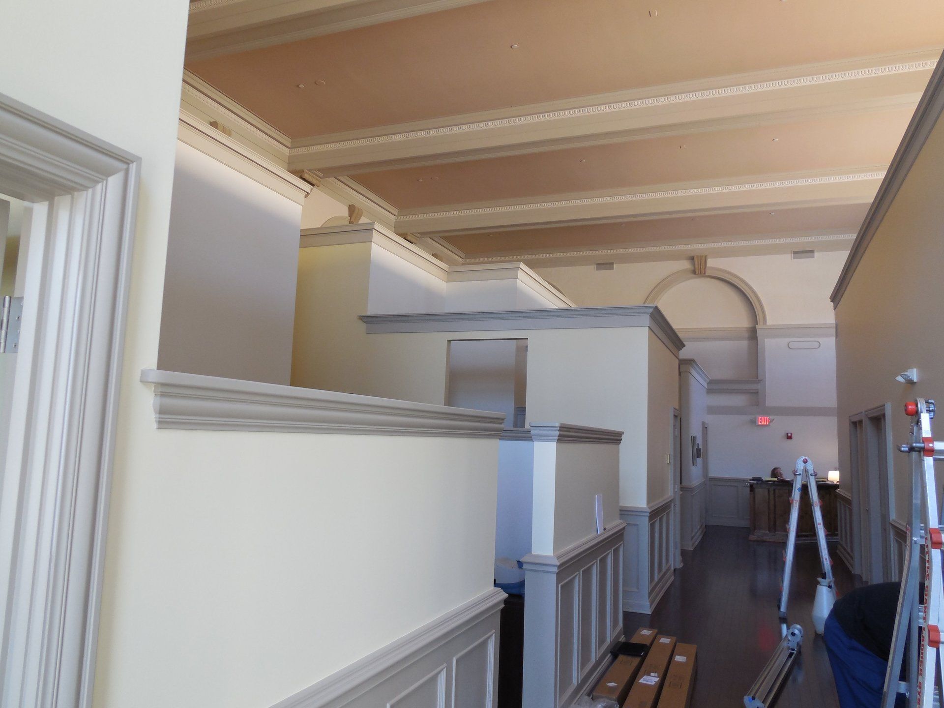 A long hallway with a ladder in the middle of it
