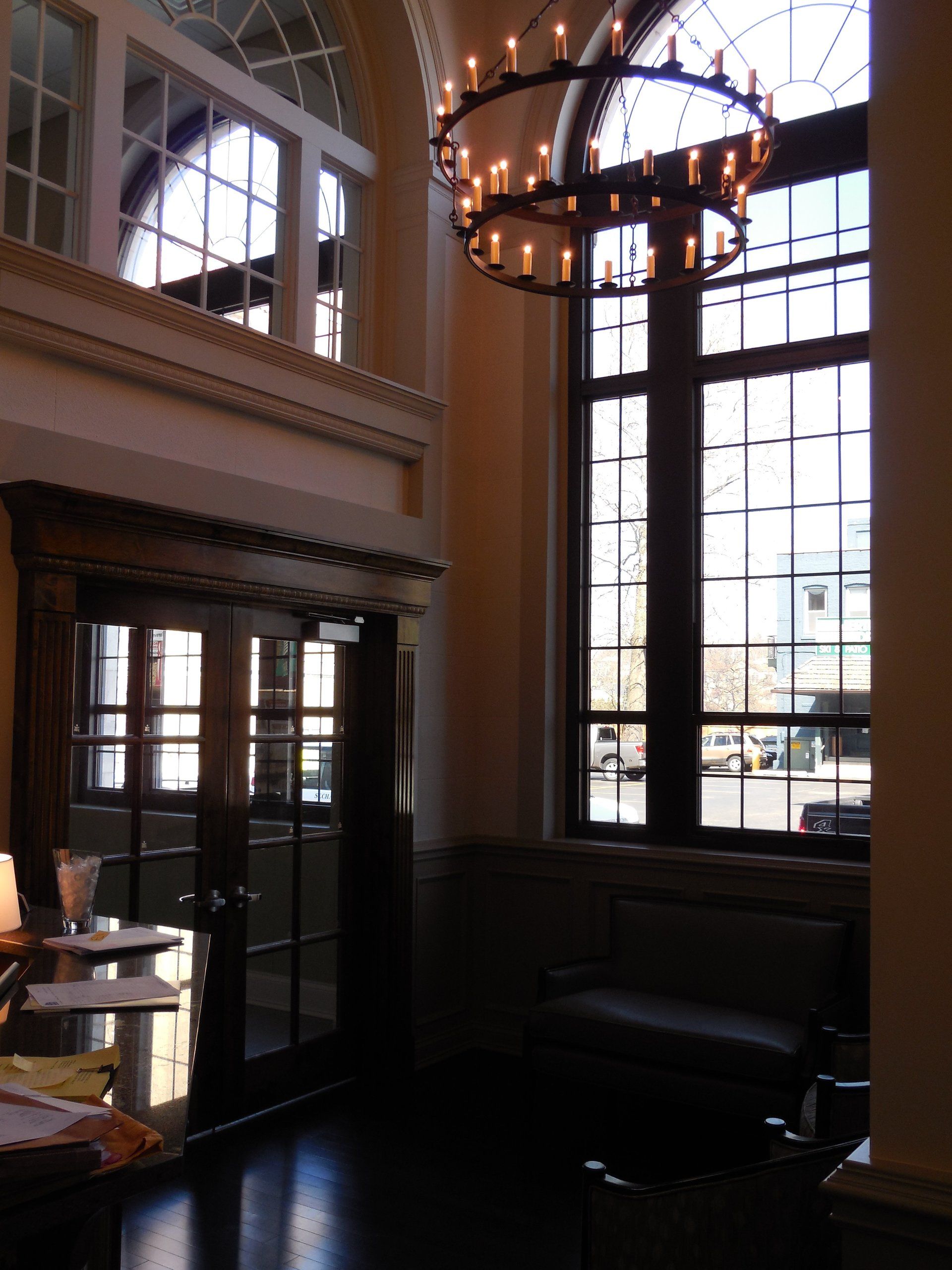 A room with a large window and a chandelier