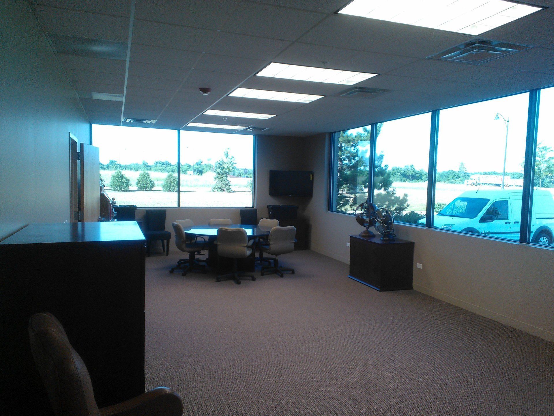 A large room with a table and chairs in it