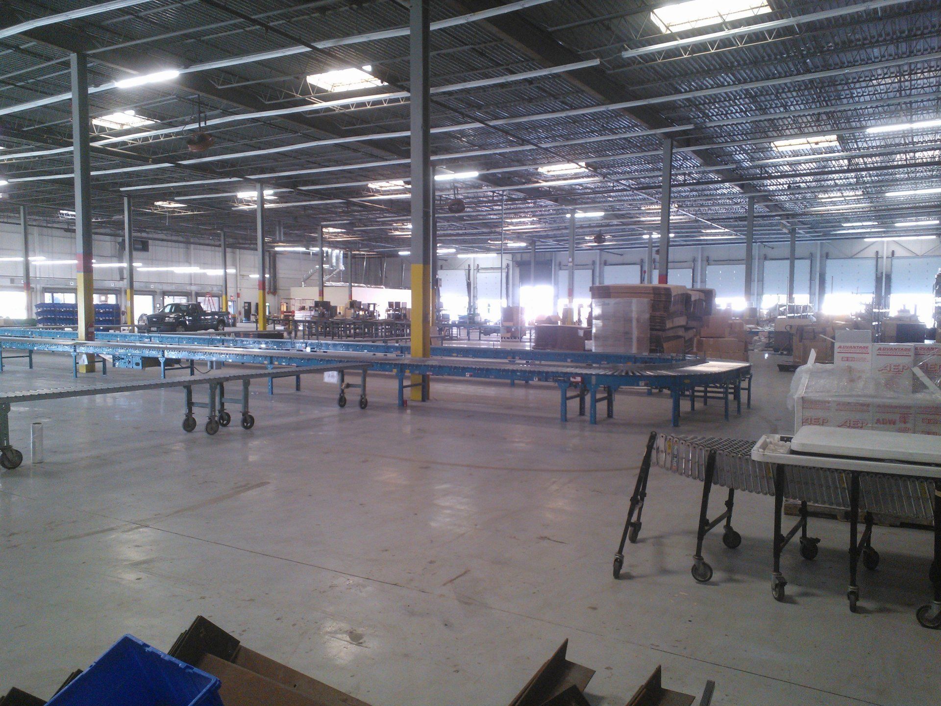 A large warehouse with a lot of tables and carts