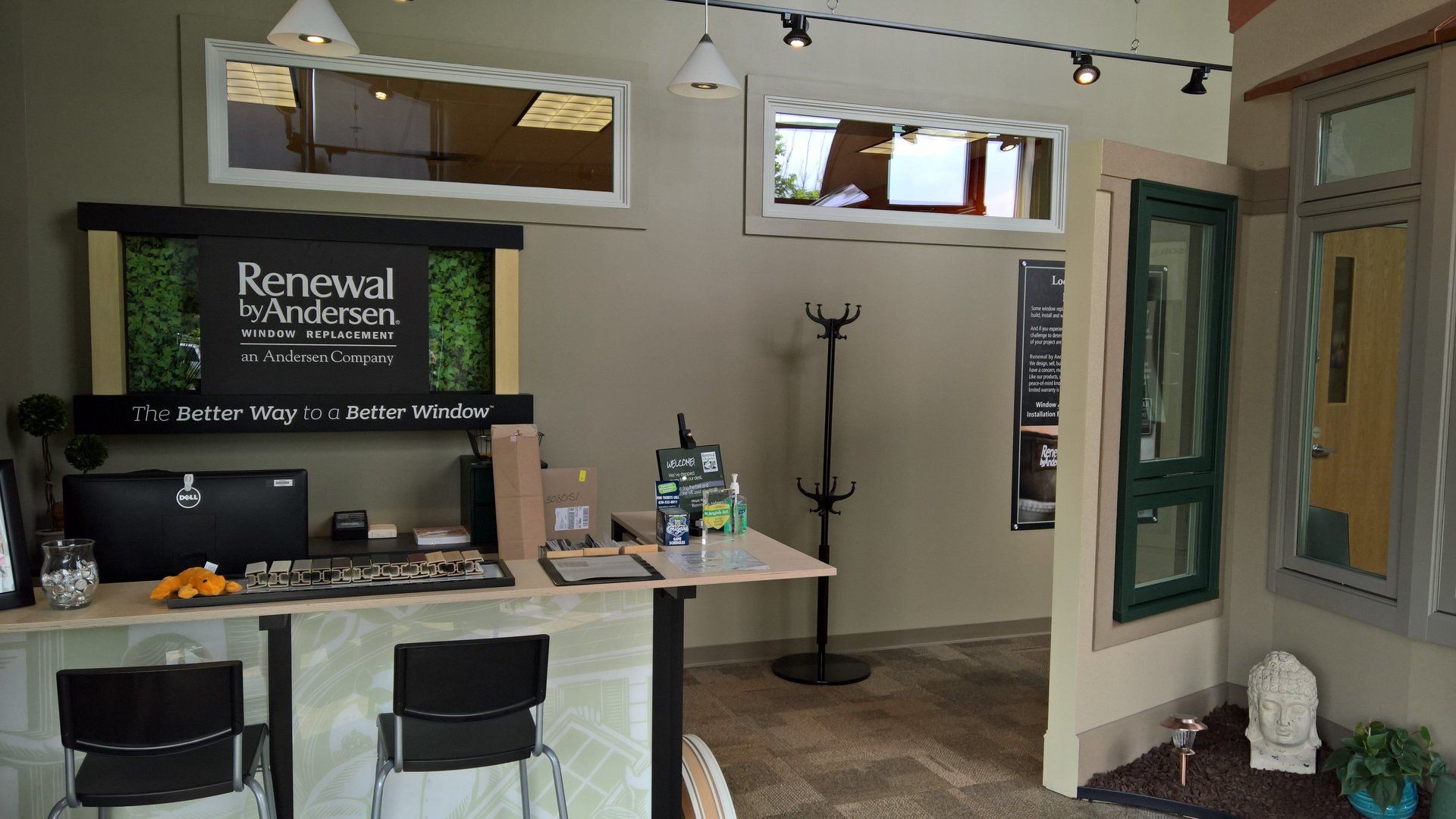 A room with a desk and chairs and a sign that says renewal
