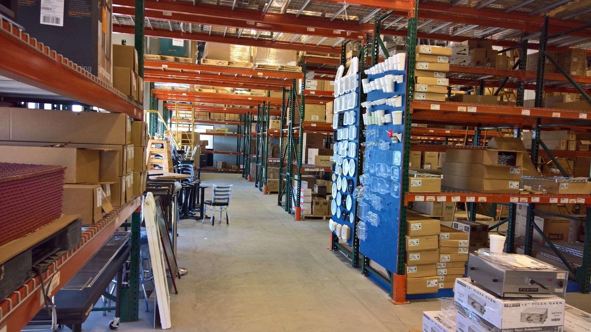 A large warehouse filled with lots of shelves and boxes