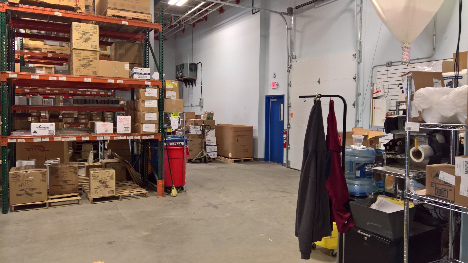 A warehouse filled with lots of boxes and water bottles