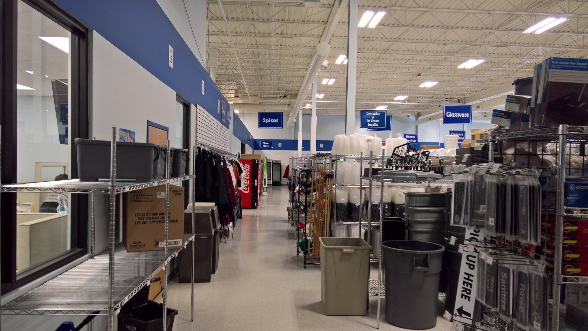 A store with a lot of shelves and trash cans