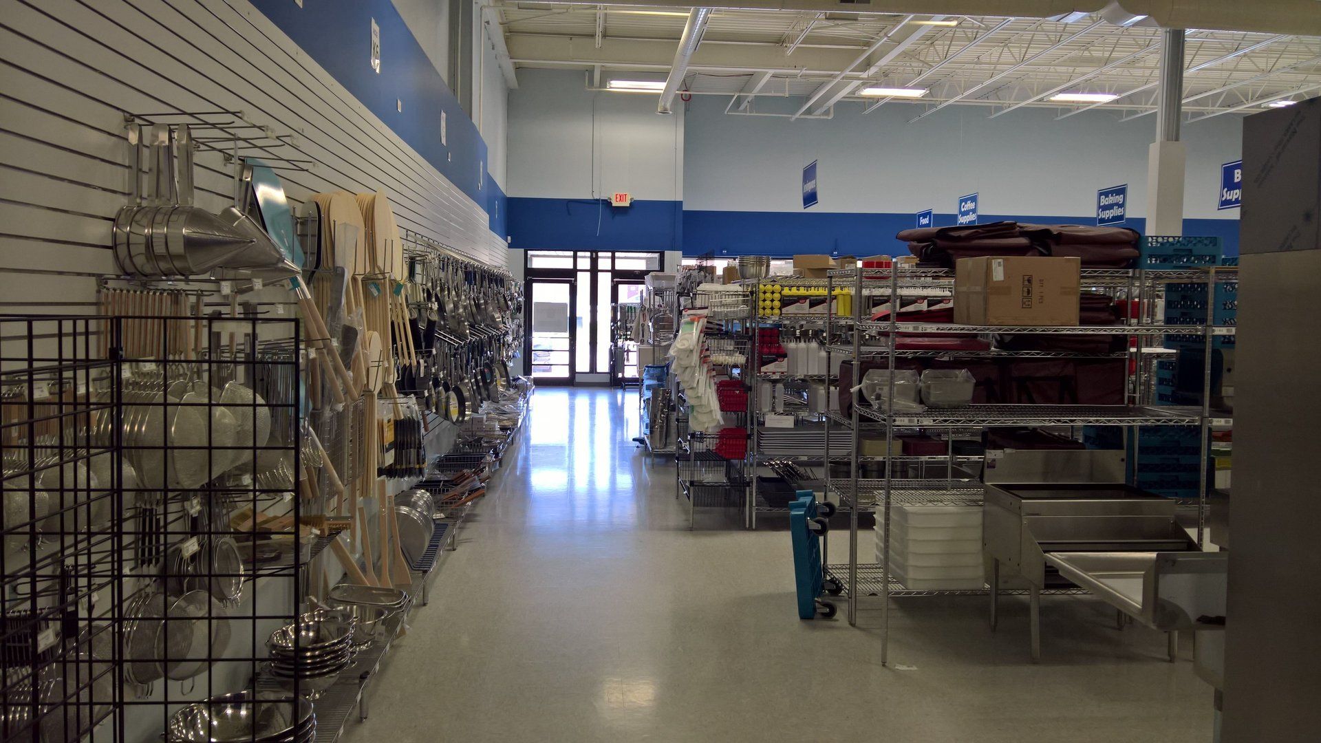 The inside of a store with a lot of shelves and a blue wall.