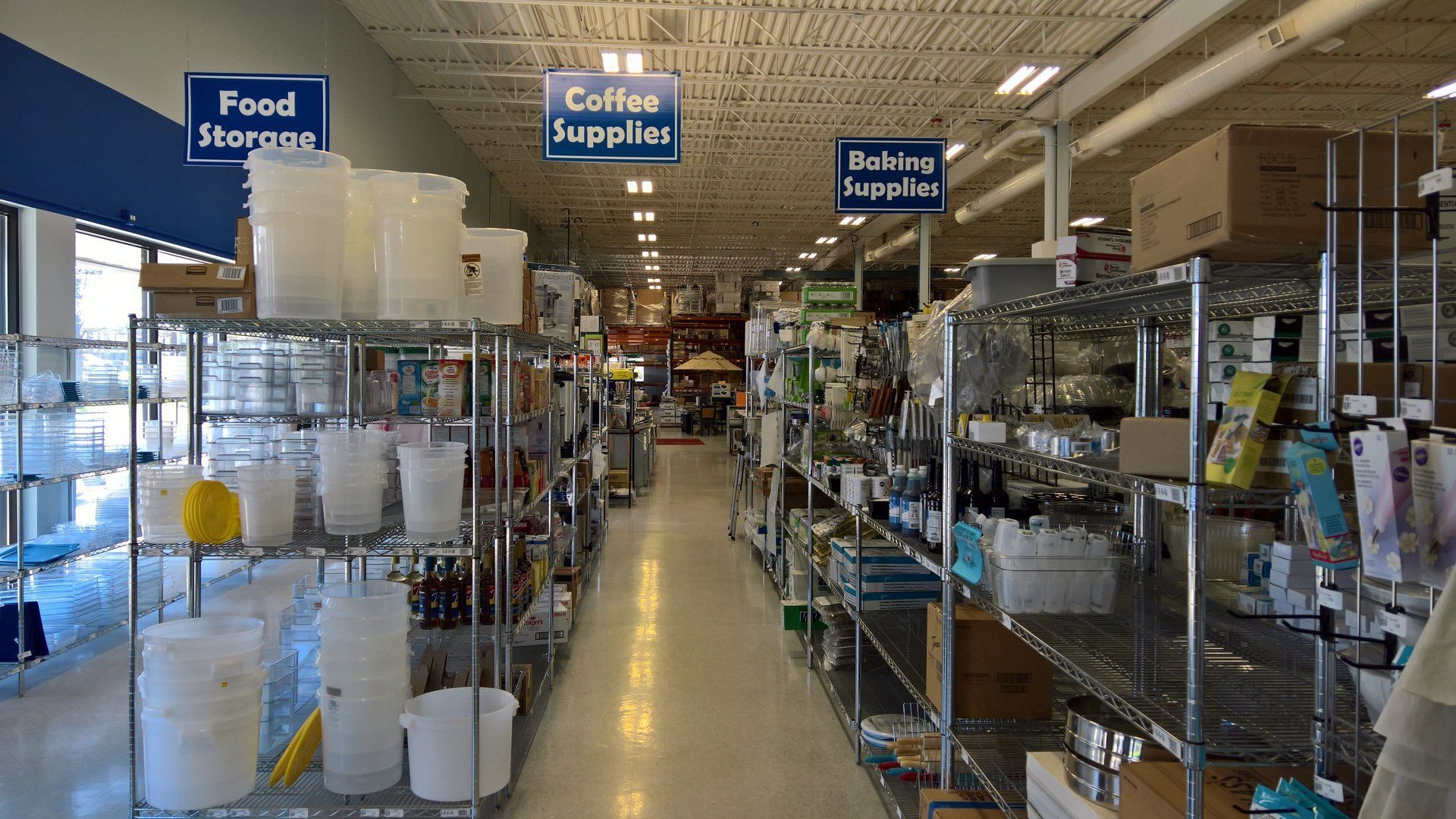 A store aisle with a sign that says food supplies
