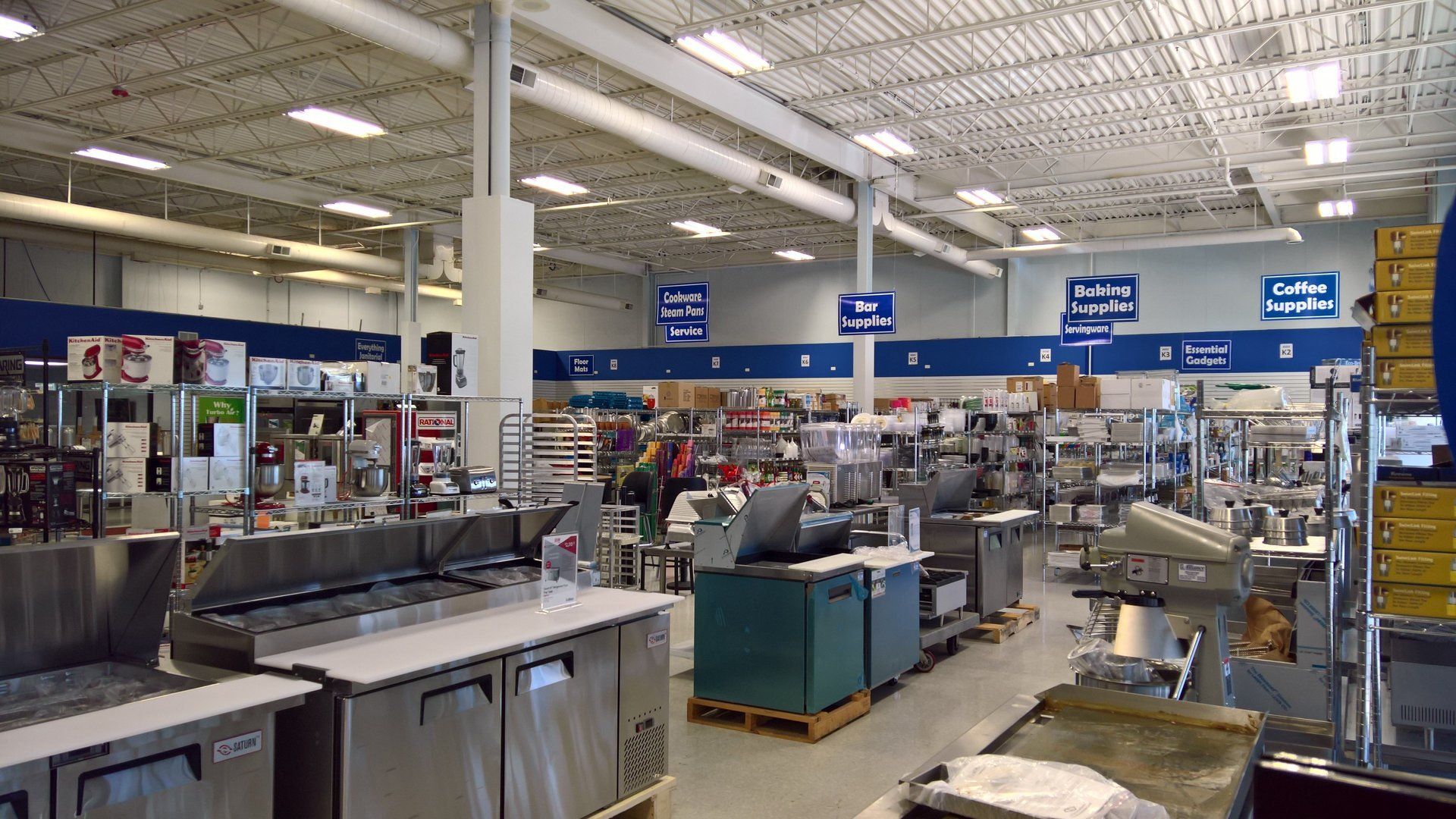 A large store filled with lots of stainless steel appliances.