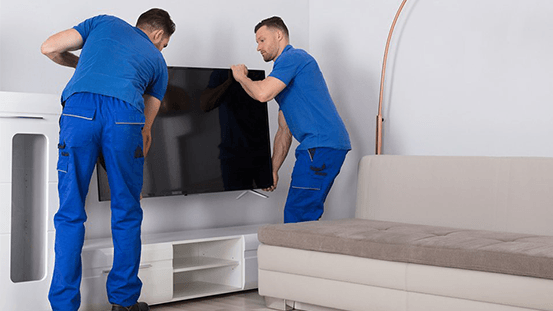 Two Workers Placing Television — Morehead City, NC — Electronics Plus Two Workers Placing Television — Morehead City, NC — Electronics Plus