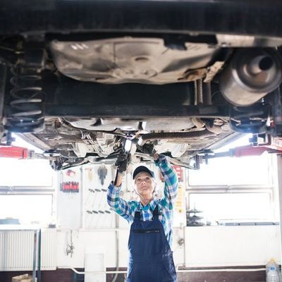 Brake Repair — Woman Repairing Car in Medford, OR Brake Repair — Woman Repairing Car in Medford, OR