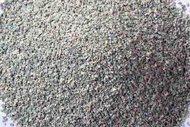 A pile of gravel is sitting on top of a white surface.