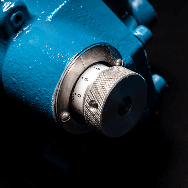 A close up of a blue machine with a knob on it