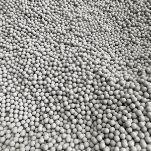 A pile of white balls sitting on top of each other on a table.