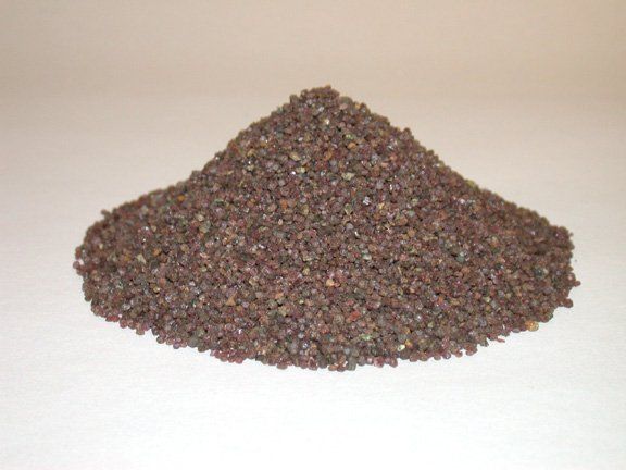 A pile of brown gravel is sitting on a white surface