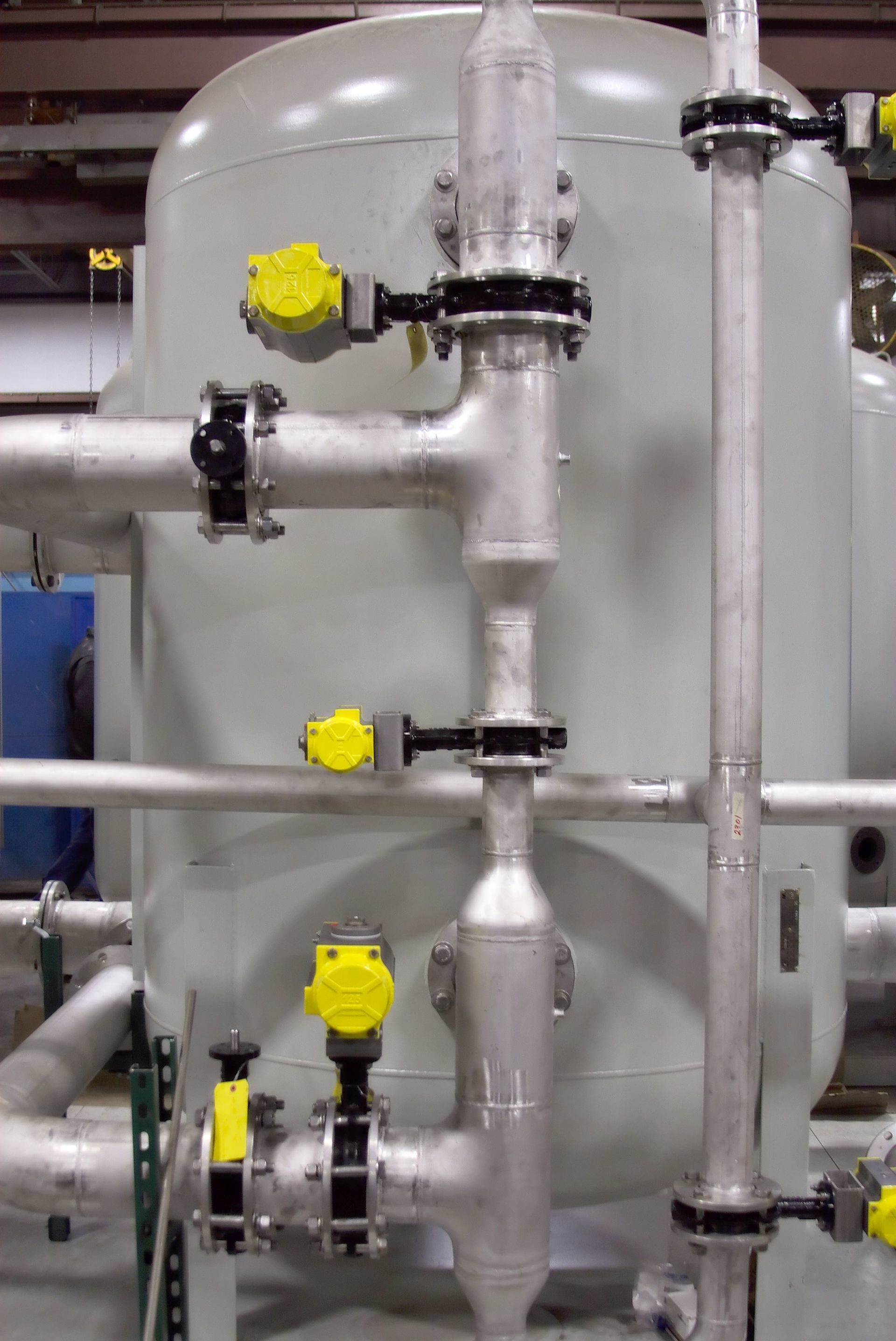 A bunch of pipes are connected to a large tank