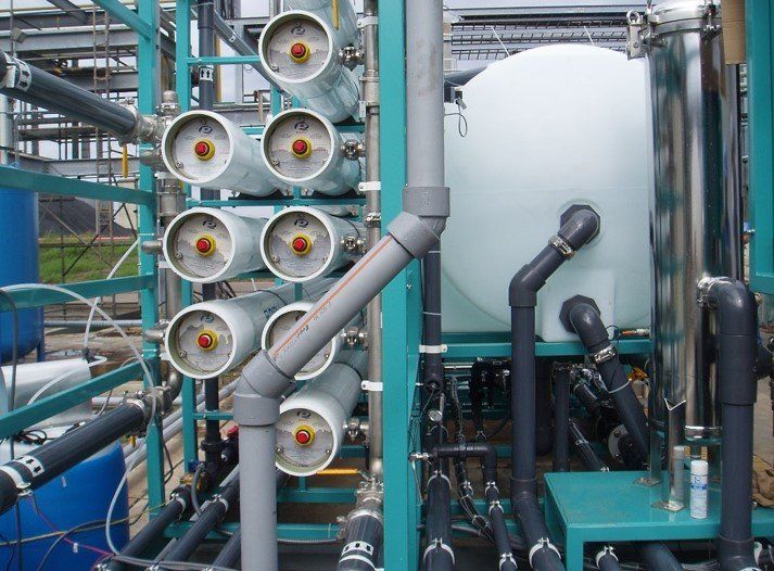 A row of pipes are lined up in a factory