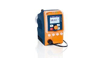 A small orange and blue device is sitting on a white surface.