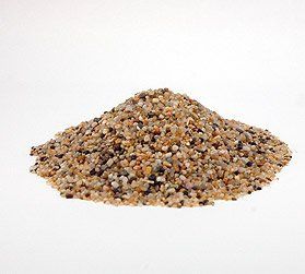 A pile of small rocks on a white surface.