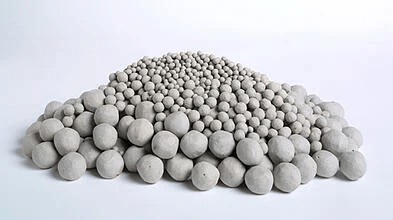 A pile of white balls on a white surface.